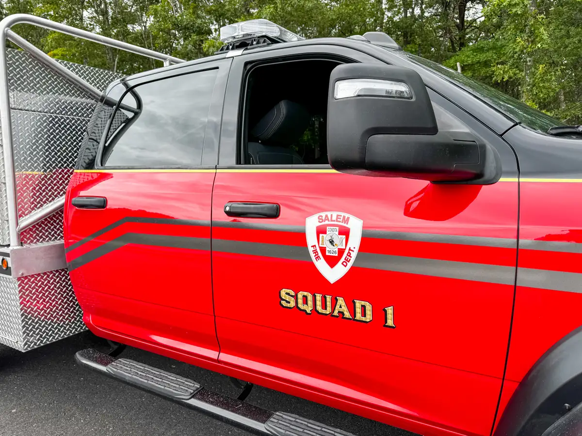 Upper side-body name panel close-up above the roll-up compartment.